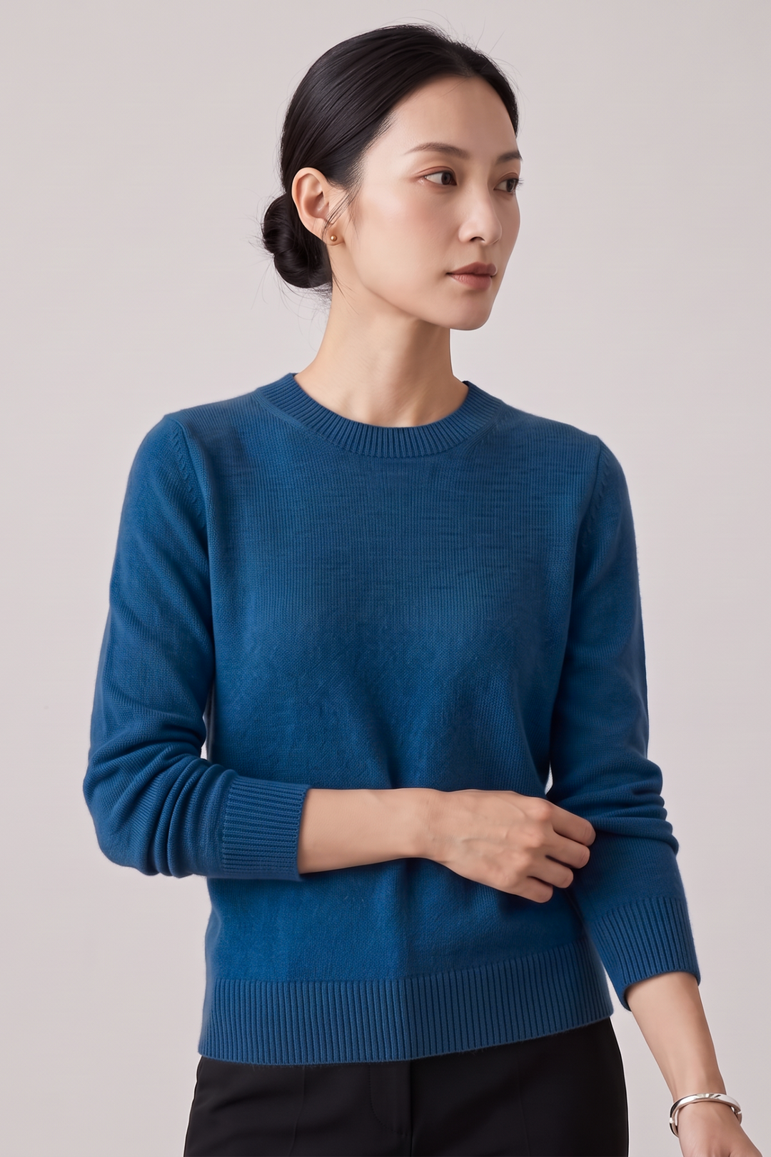 Woman wearing a Just Perfect Collection Online blue cashmere crew neck sweater with ribbed cuffs and hem.