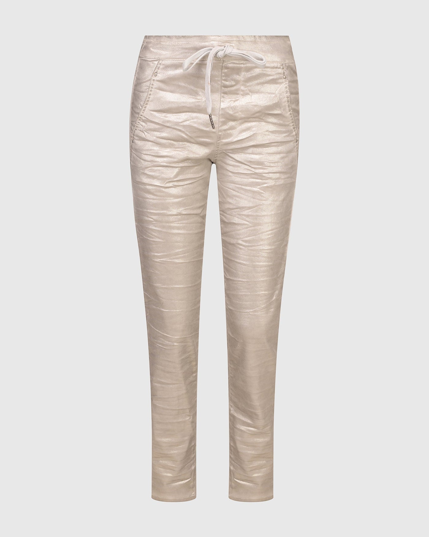 A woman's ultra-soft beige Iconic Stretch Jeans with zippers from ALEMBIKA with a Metallic Luster.