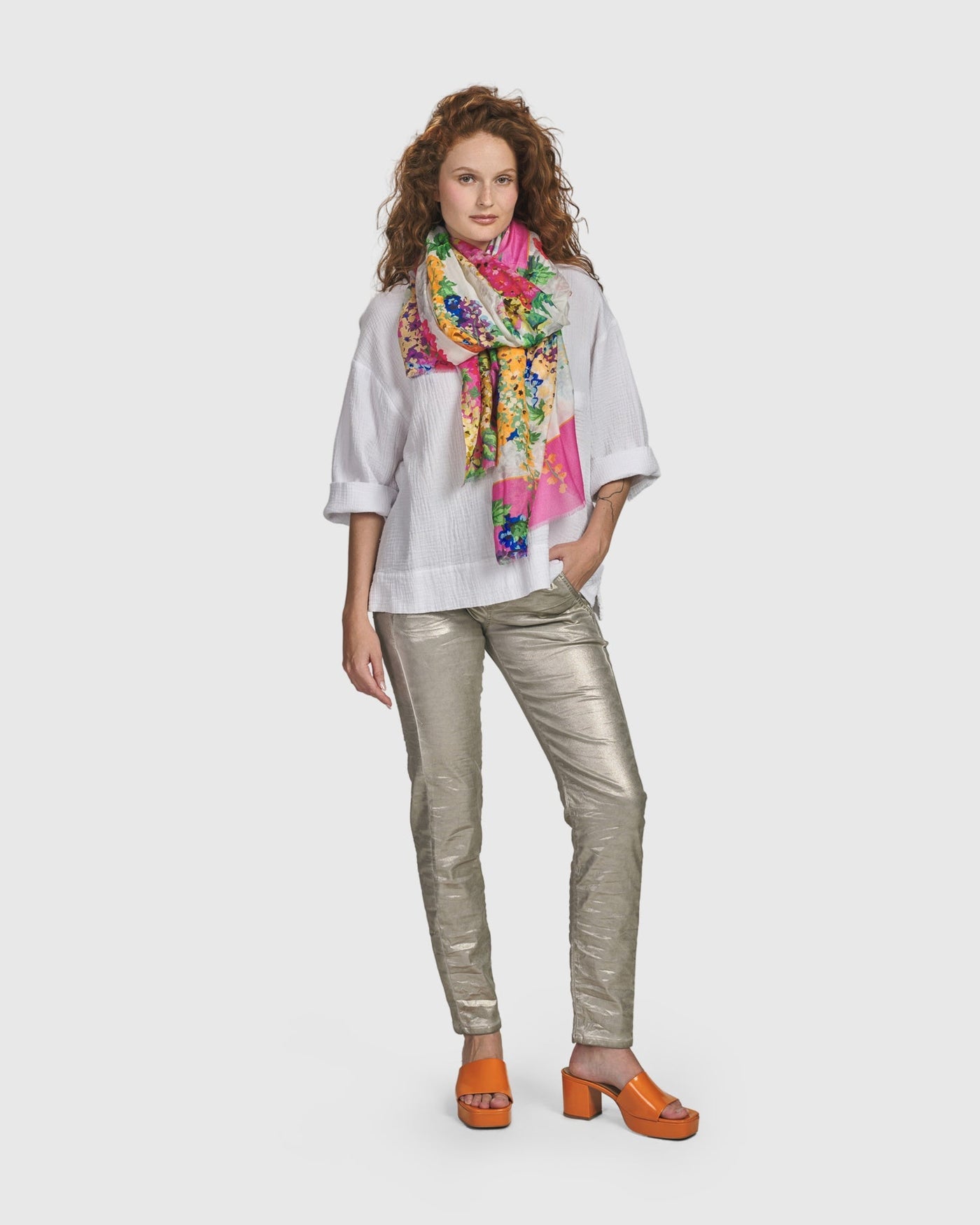 A woman wearing ALEMBIKA's Iconic Stretch Jeans in Metallic Luster with a drawstring stretch waist.