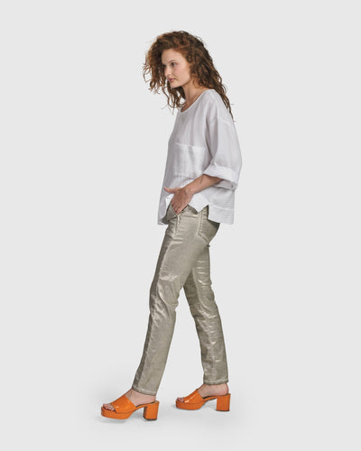 A woman wearing a white shirt and Iconic Stretch Jeans with a metallic luster and an ultra-soft feel, by ALEMBIKA.
