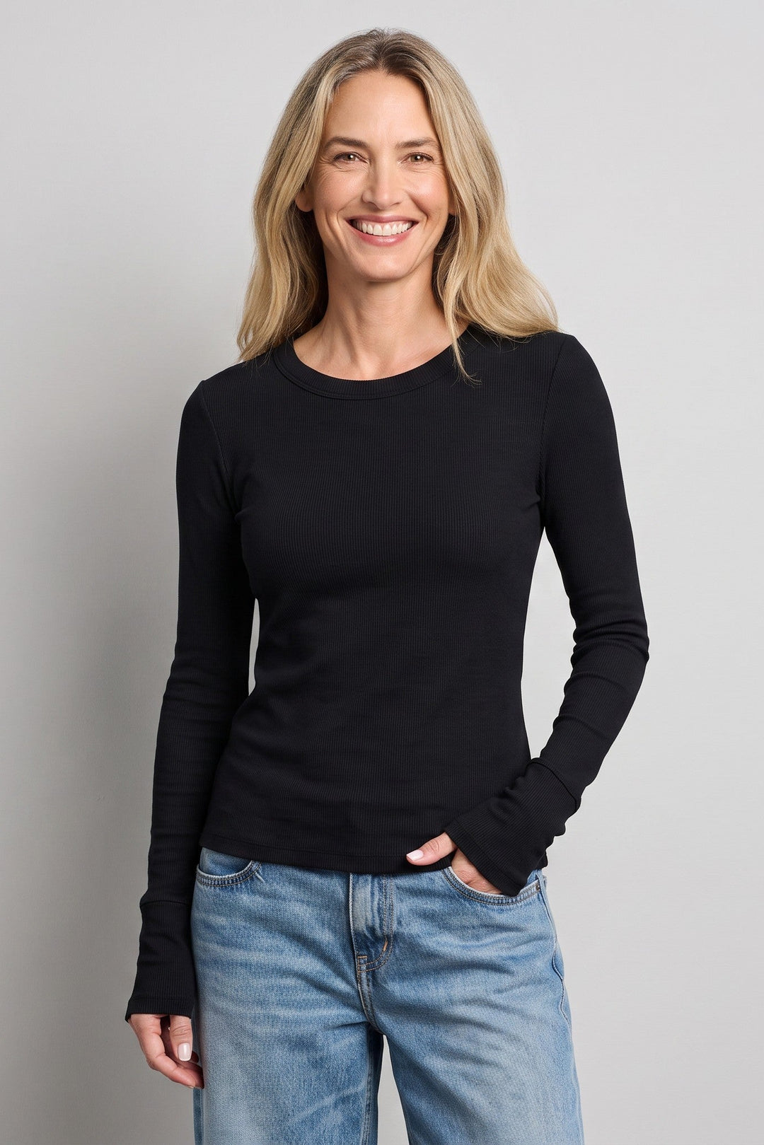 Woman wearing a Just Perfect Collection Online black long sleeve Supima cotton tee with blue jeans