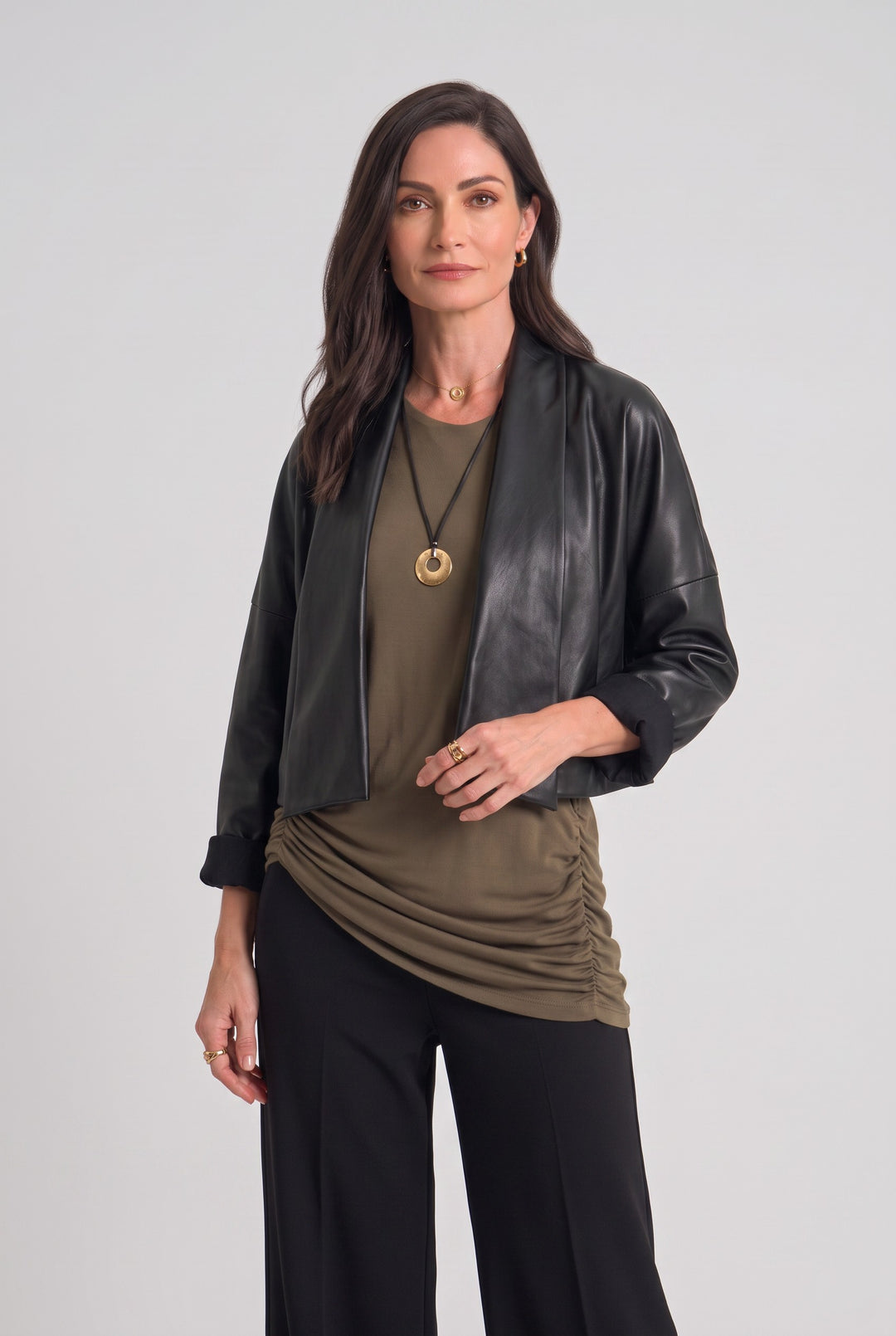Model wearing a Just Perfect Collection Online black Origami Jacket with a structured open front and cropped sleeves.