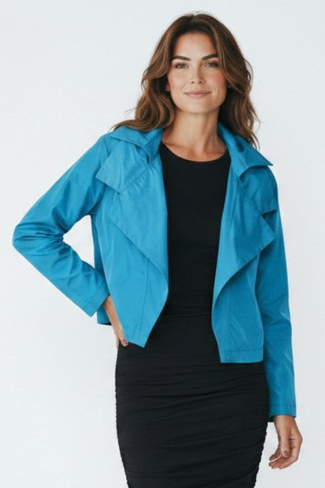 Just Perfect Collection Online blue nylon triple collar jacket worn by a woman over a black dress.