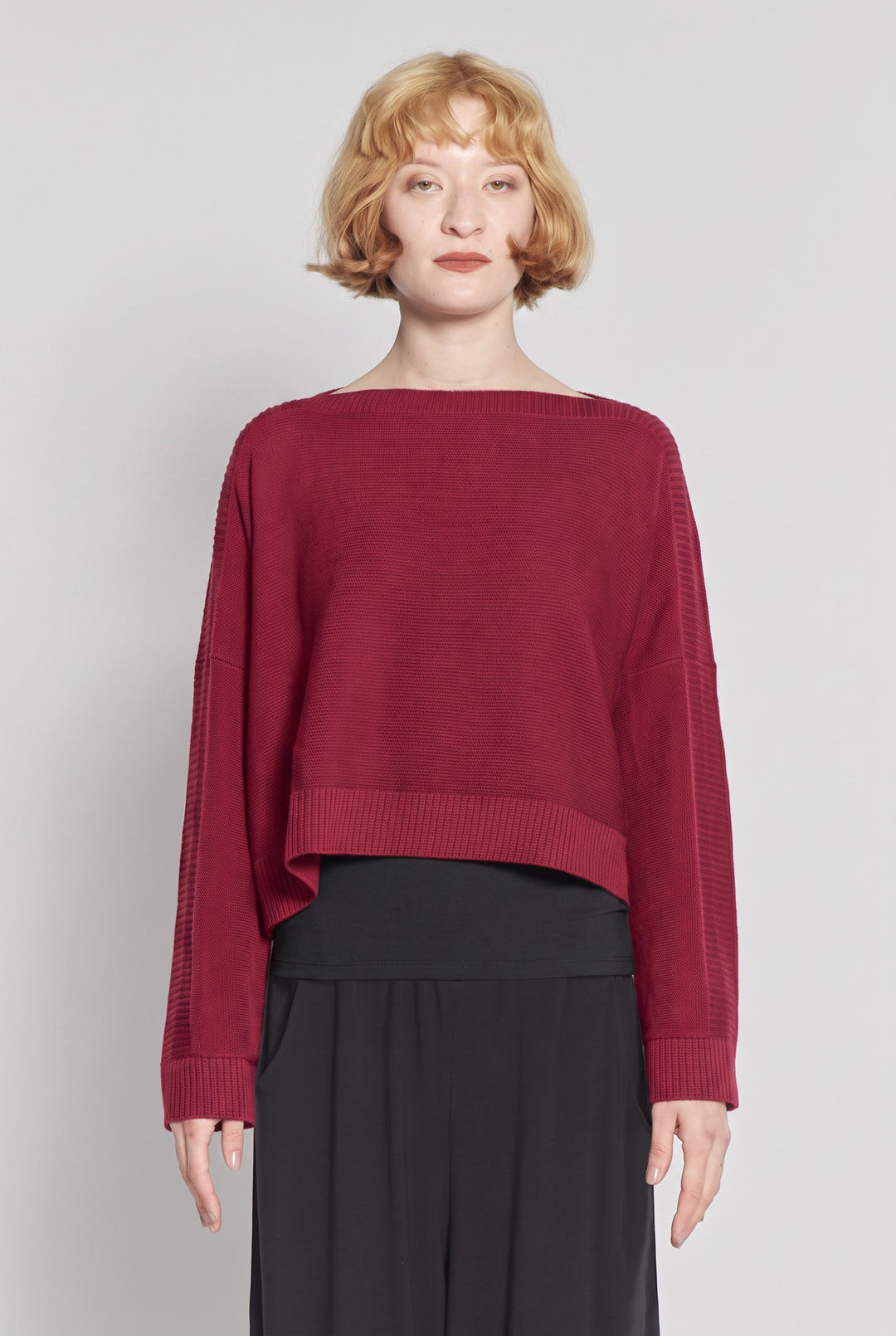Model wearing a cherry red Just Perfect Collection Online Georgia boatneck sweater with a cropped boxy fit