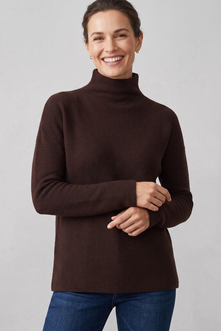 Just Perfect Collection Online chocolate brown cashmere funnel neck sweater with textured knit on a smiling woman.