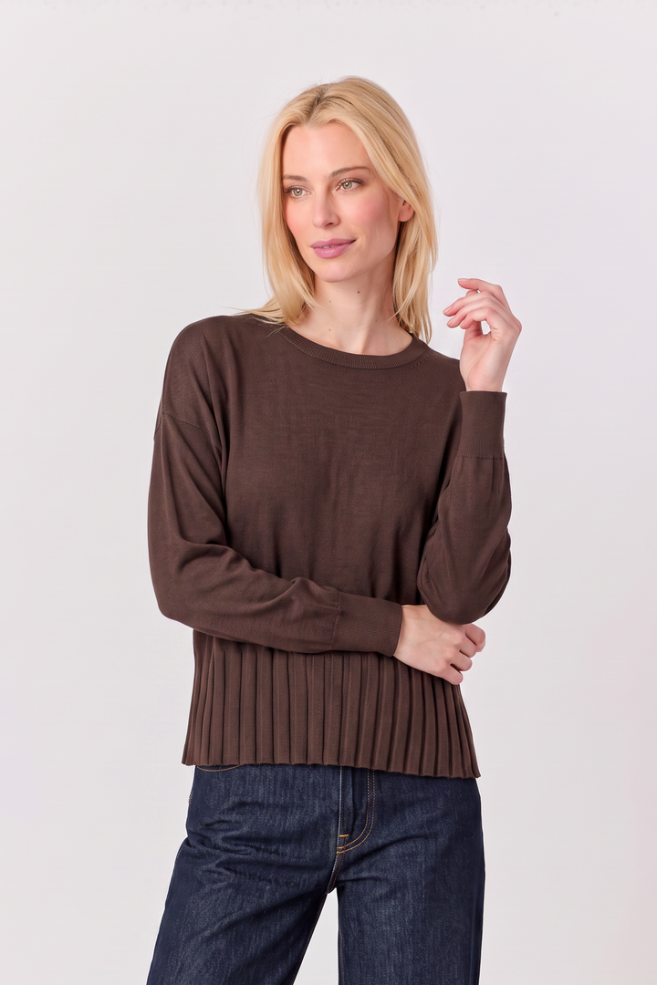 Model wearing a Just Perfect Collection Online coffee brown sweater with a ribbed hem and long sleeves.