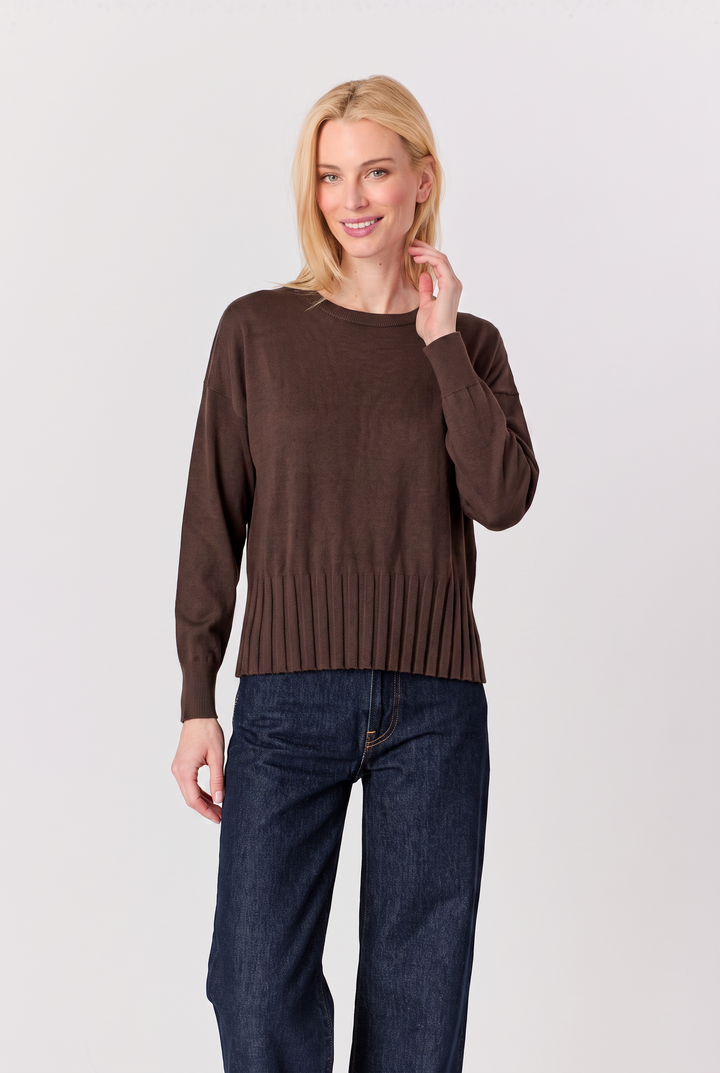 Just Perfect Collection Online coffee brown sweater with a ribbed hem worn by a blonde model with dark denim jeans