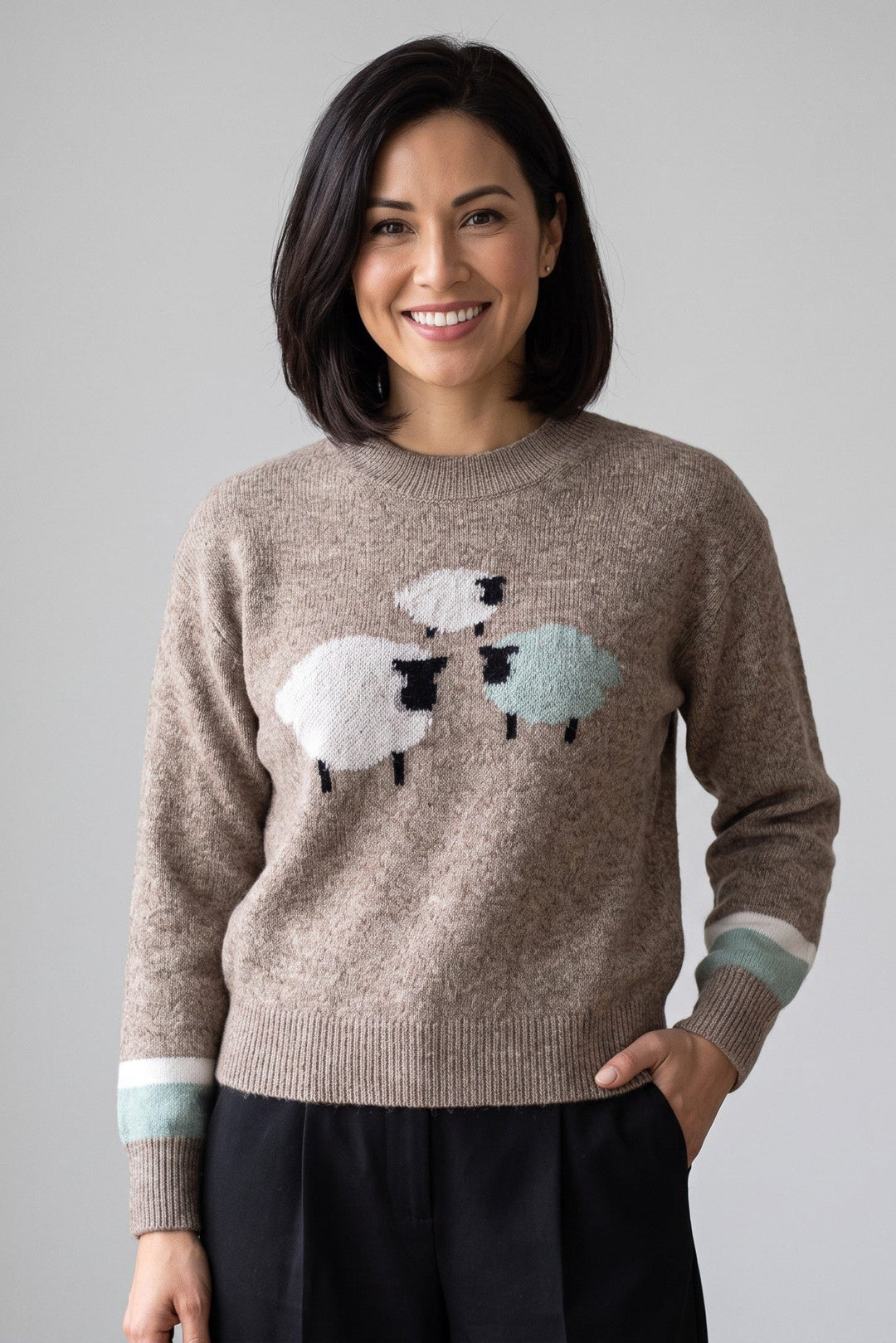 Just Perfect Collection Online coffee brown Herdwick wool crew sweater with sheep motif and striped cuffs on a woman