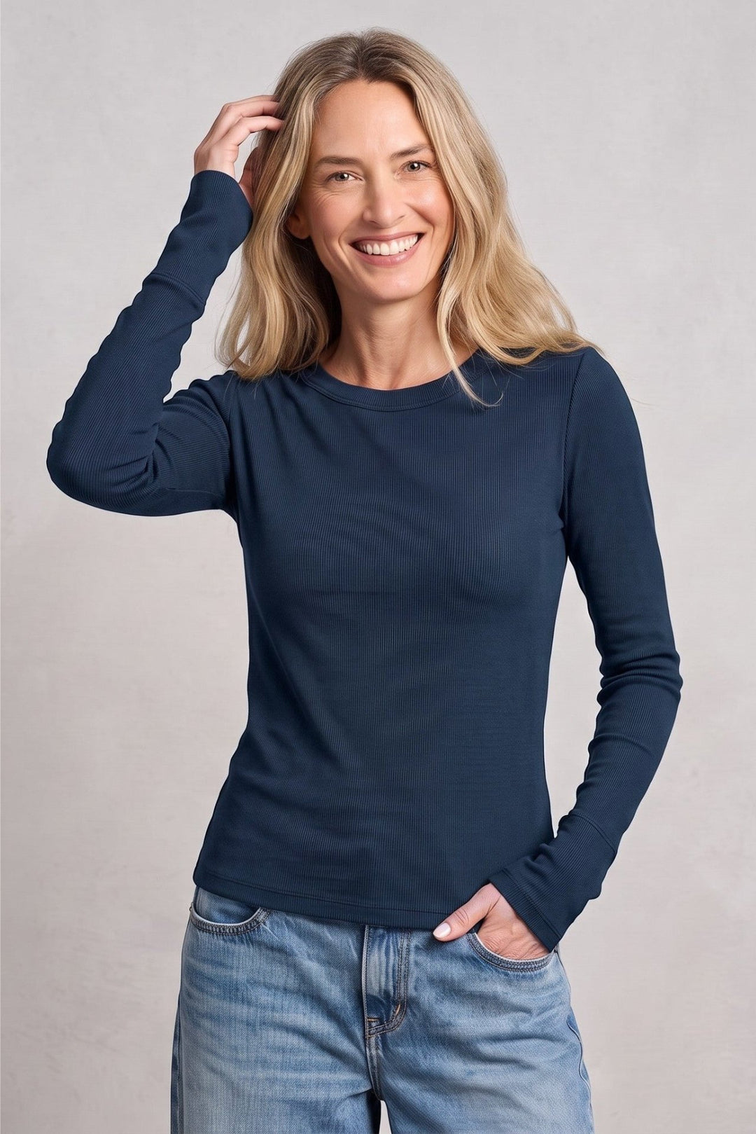 Woman wearing a Just Perfect Collection Online Kelso long sleeve tee in lagoon blue Supima cotton with jeans