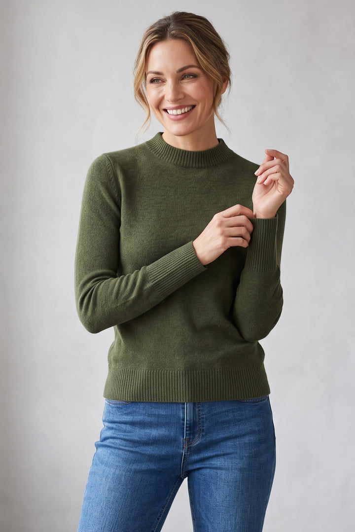 Woman wearing a Just Perfect Collection Online olive green 100% cashmere crew neck sweater with blue jeans.