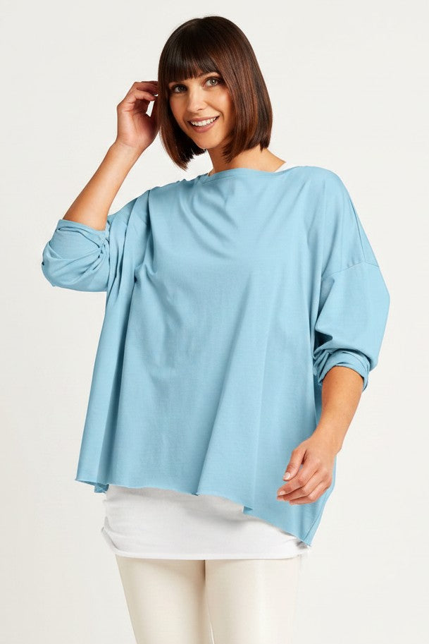 Just Perfect Collection Online Pima cotton boxy tee in cameo blue with wide neckline, layered over white camisole and cream pants.