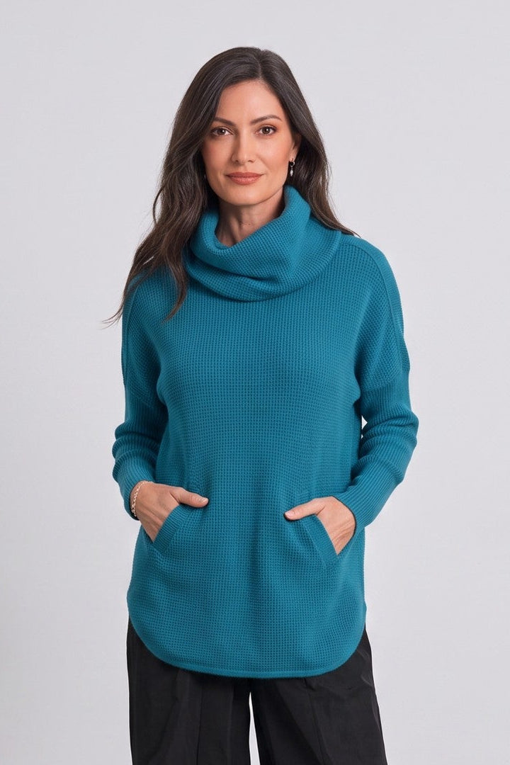 Model wearing a Just Perfect Collection Online teal Pima cotton waffle-knit cowl neck sweater with a curved hem.