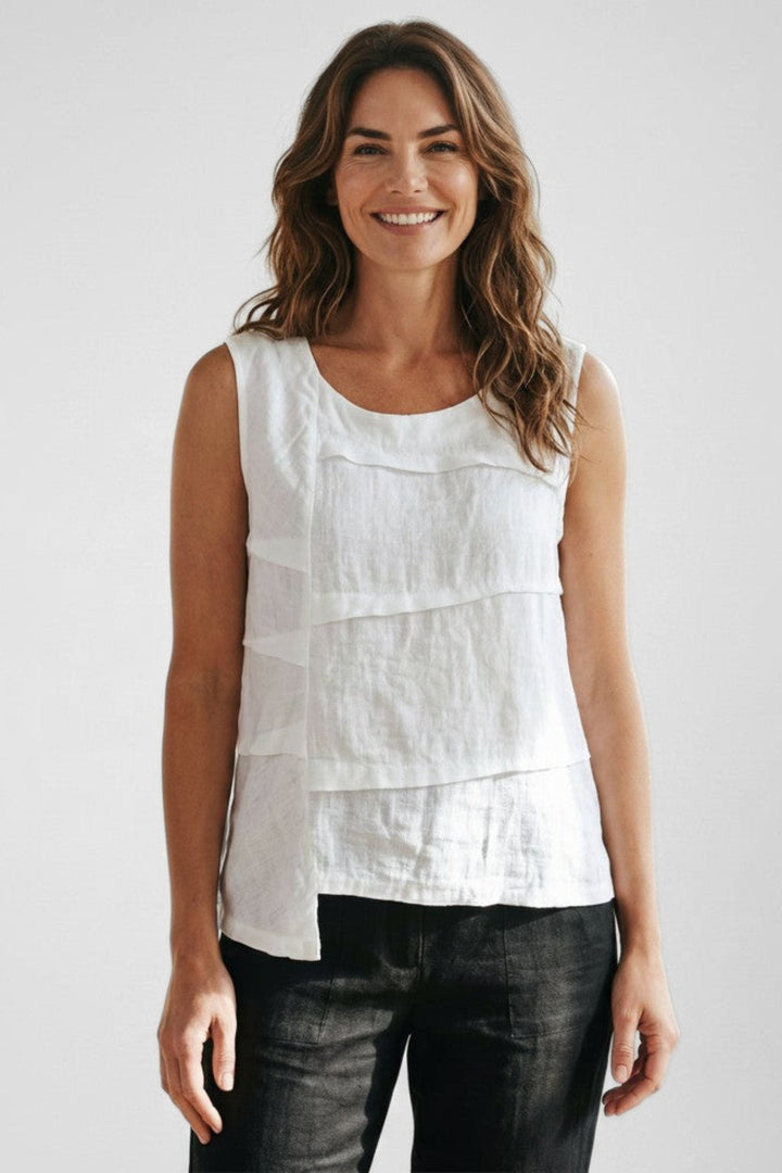 Model wearing a Just Perfect Collection Online white linen sleeveless tuck top with an asymmetric hemline.