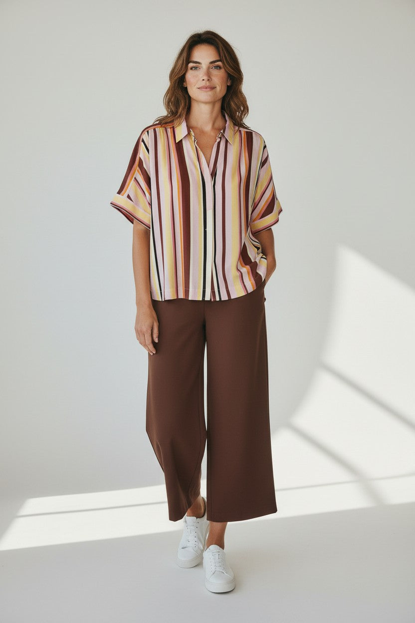 Just Perfect Collection Online Lesly short sleeve shirt with vertical stripes in rose, brown, yellow, and pink. Features a collar and button-up front.