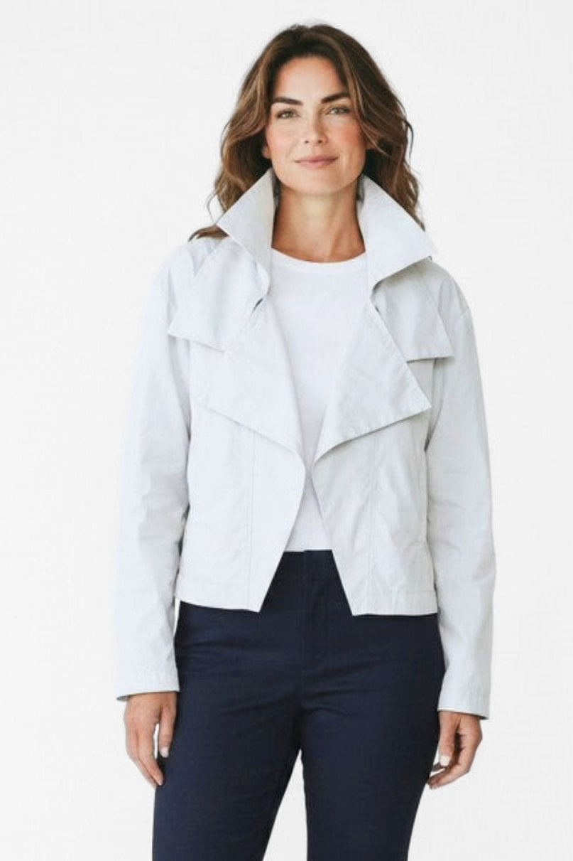 Just Perfect Collection Online white nylon triple collar jacket worn by a woman with blue jeans and white sneakers.