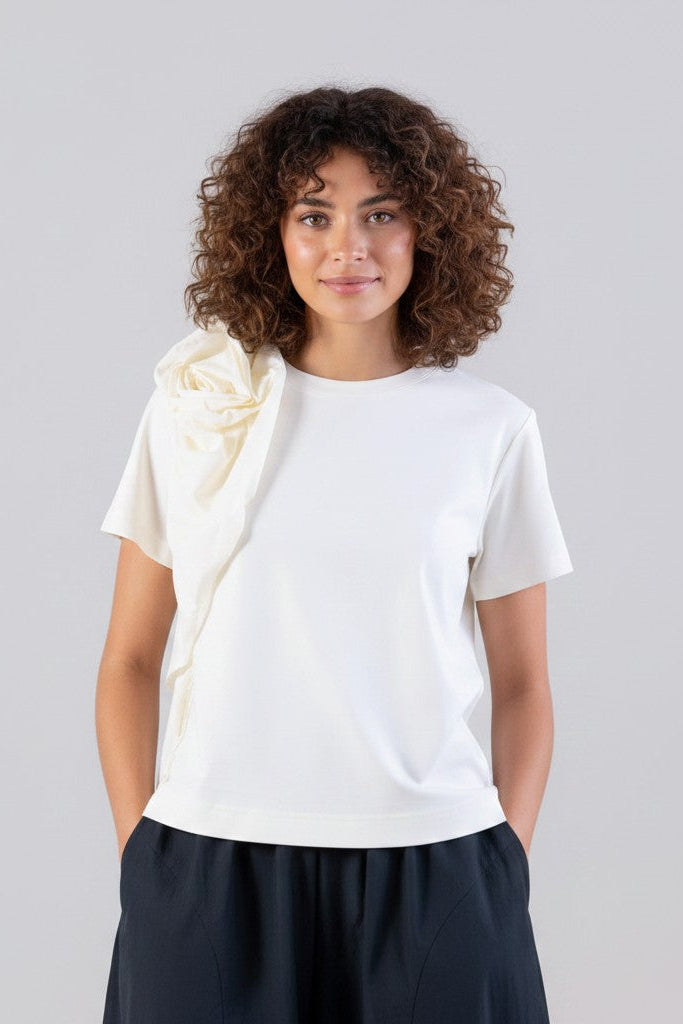 Just Perfect Collection Online white short sleeve t-shirt with a large ruffle detail on the left shoulder.